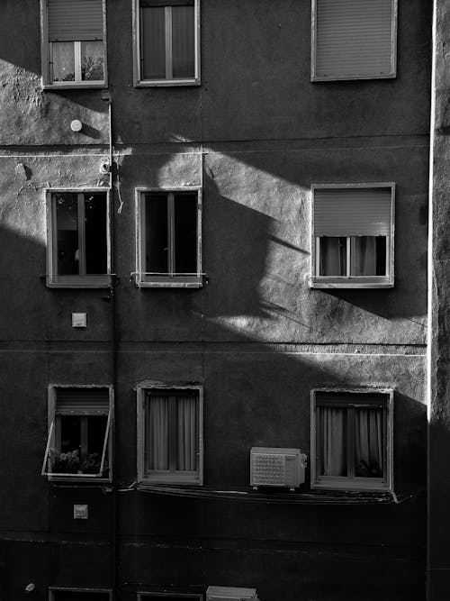 Black and White Photo of an Apartment Block in City 