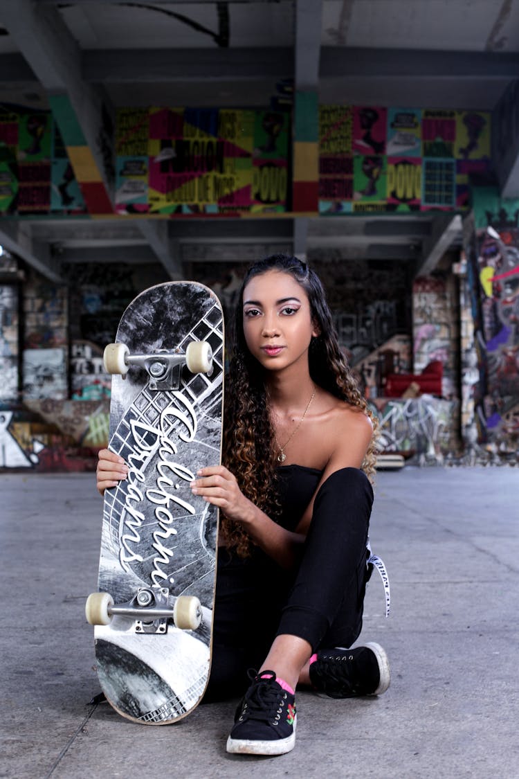 Woman In Black Holding Skateboard