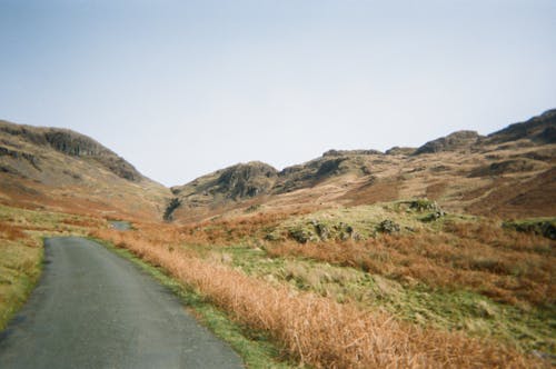 Hills around Empty Road in Countryside