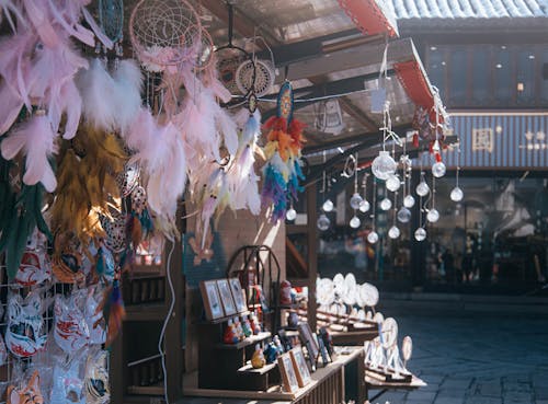 Free Vibrant dream catchers and trinkets displayed at an urban market stall. Perfect for adding boho charm to any space. Stock Photo