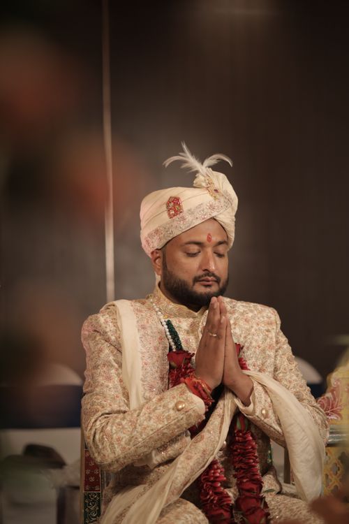 Free A Hindu groom in Raipur, India, in traditional wedding attire with eyes closed, praying. Stock Photo
