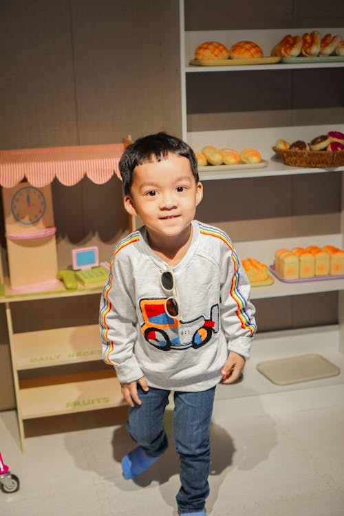 A Little Boy Playing with a Mini Kitchen Set