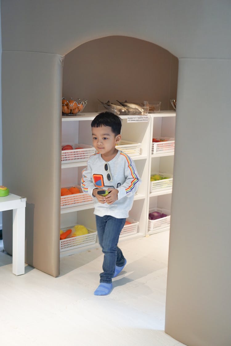 A Toddler Walking In A Playroom 