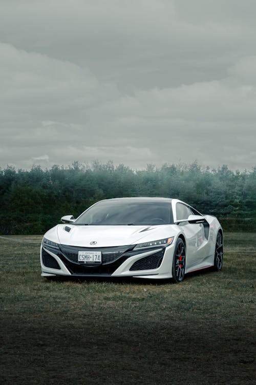 A White 2017 Acura NSX Parked on a Field 