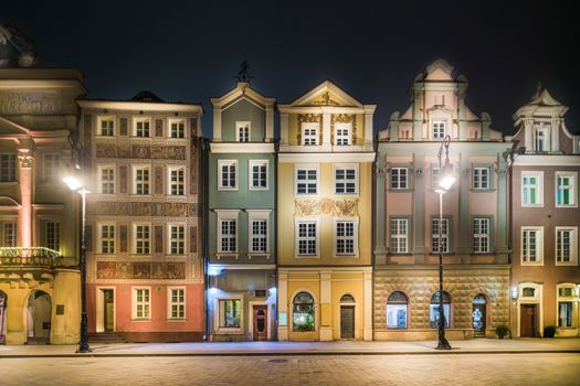 Stunning night view of colorful historic buildings in Poznań, Poland's Old Town Square.