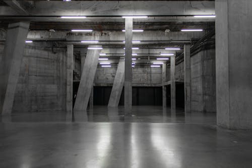 Empty Concrete Hall Illuminated with Fluorescent Lamps