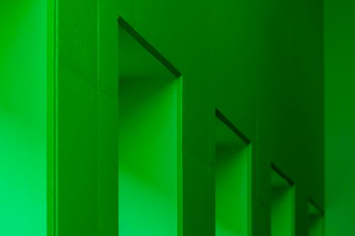 Free A monochrome geometric pattern of green walls and shadows creates a modern interior design aesthetic. Stock Photo