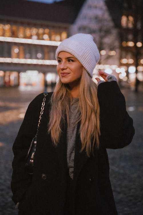 A Woman Standing in a City 