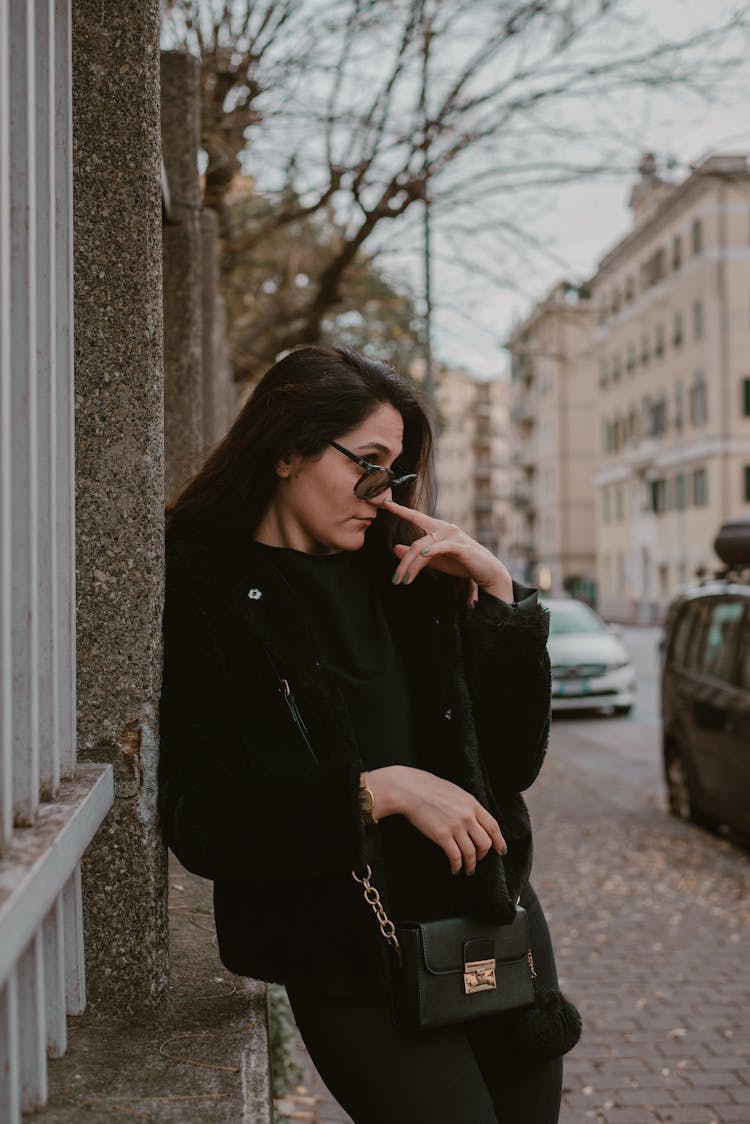 Woman In Black Looking Over Sunglasses