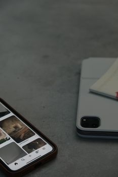 A close-up of smartphones on a gray surface displaying touchscreen technology.
