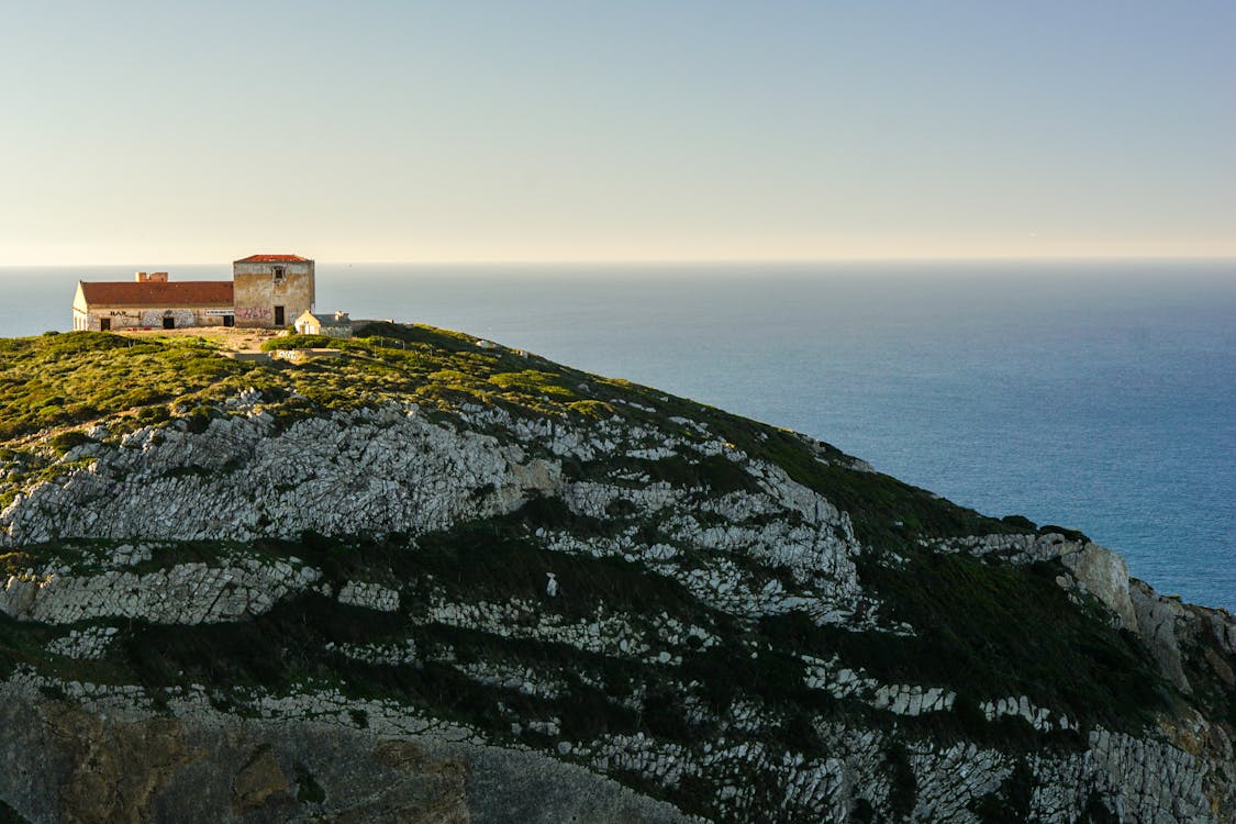 Building on Hill Overlooking Sea · Free Stock Photo