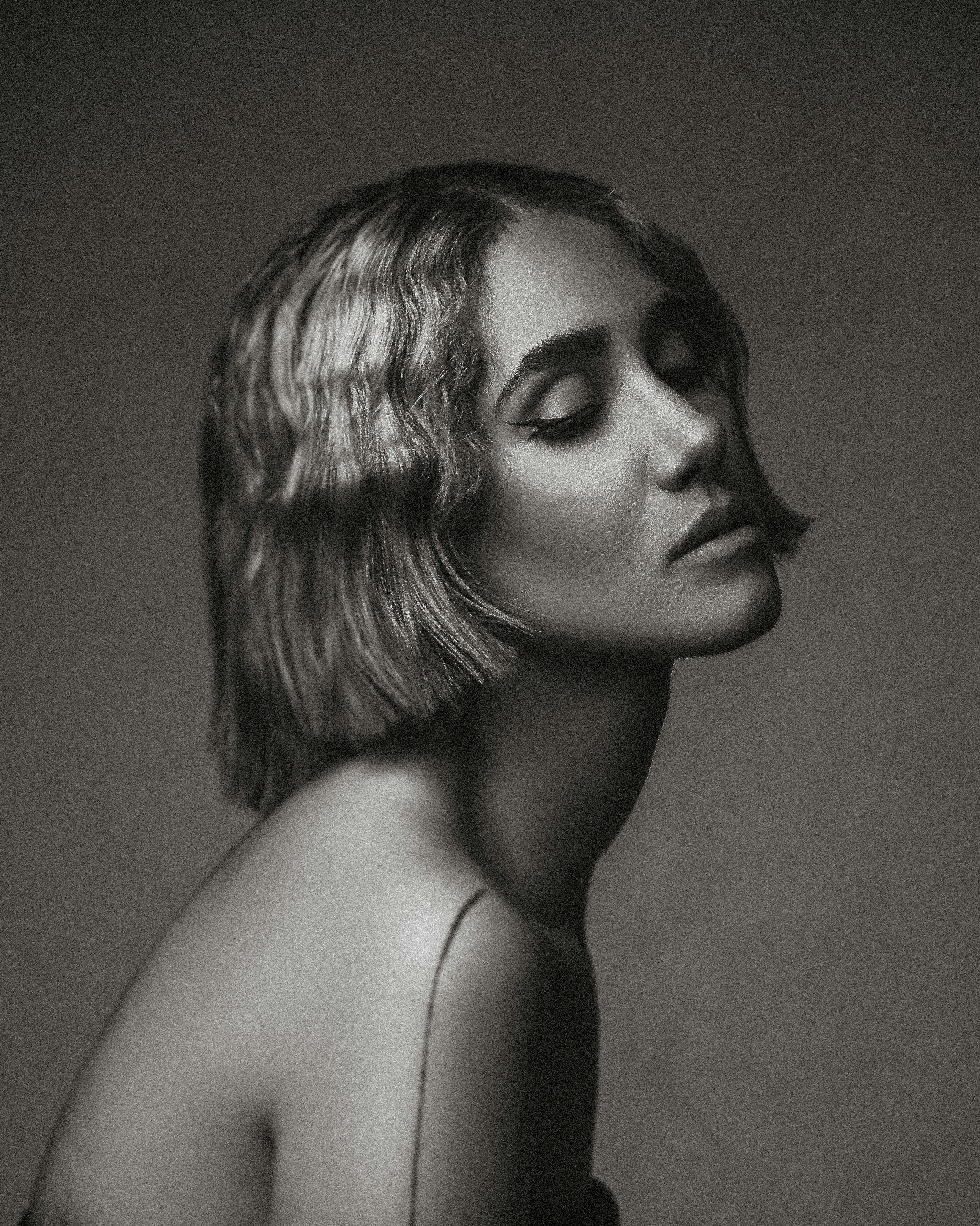 Artistic sensual woman with eyes closed in deep surrender, soft focus intimate mood