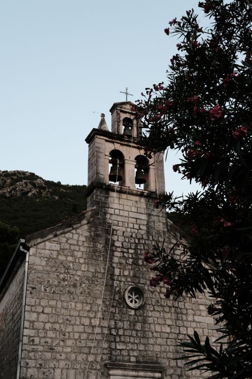 Free Scenic view of a historic stone church with bell tower in Montenegro, surrounded by nature. Stock Photo