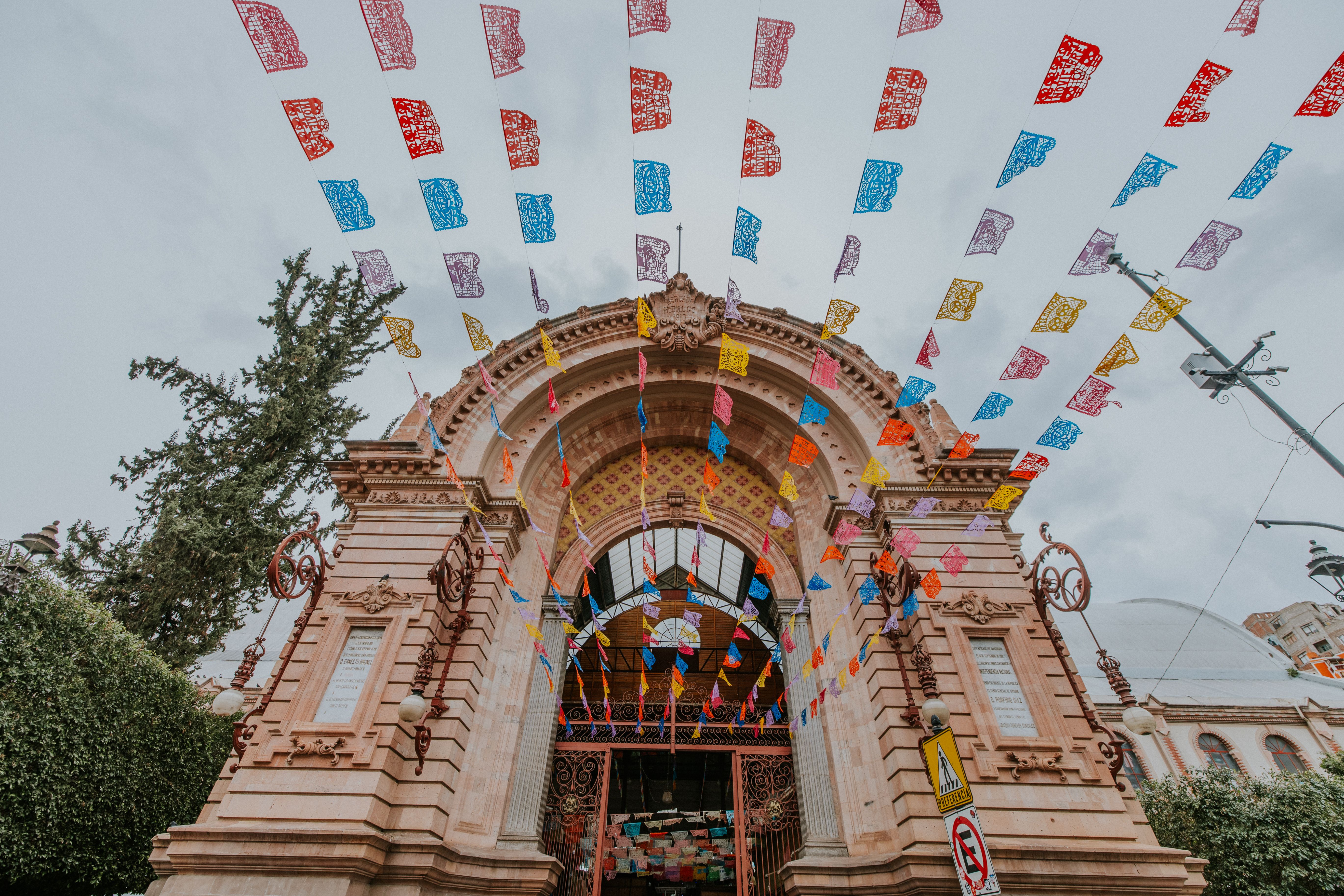 Vibrant flags adorn the entrance of Mercado Hidalgo, a historic market in Guanajuato, Mexico.