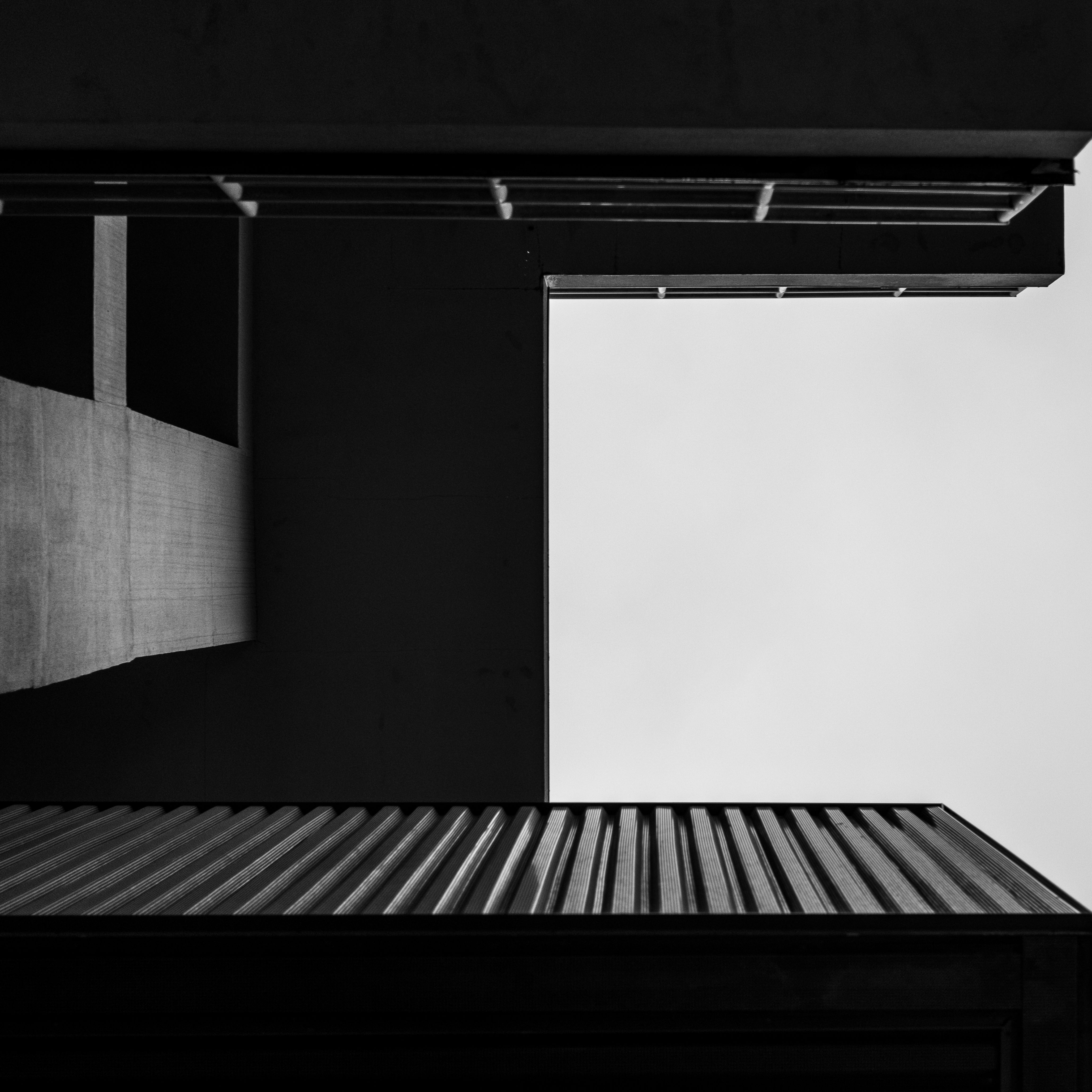 Striking black and white shot of modern architecture with geometric lines and contrasts.