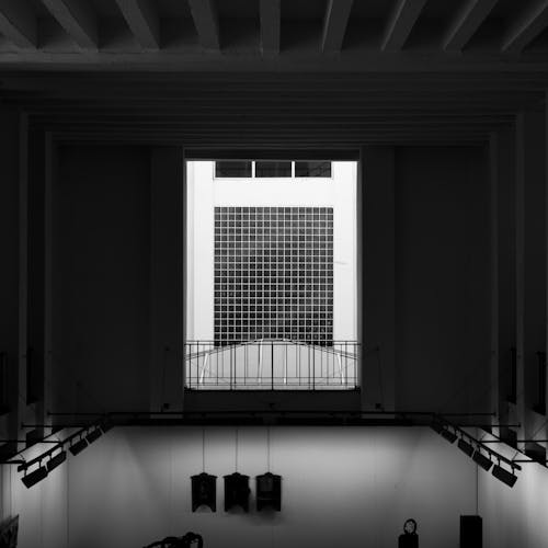 A black and white photo of a room with a window