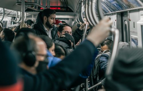 Free A dense crowd of commuters standing inside a busy subway train in New York City. Stock Photo