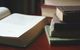 Aged hardbacks stacked on wood — photo by Suzy Hazelwood on Pexels