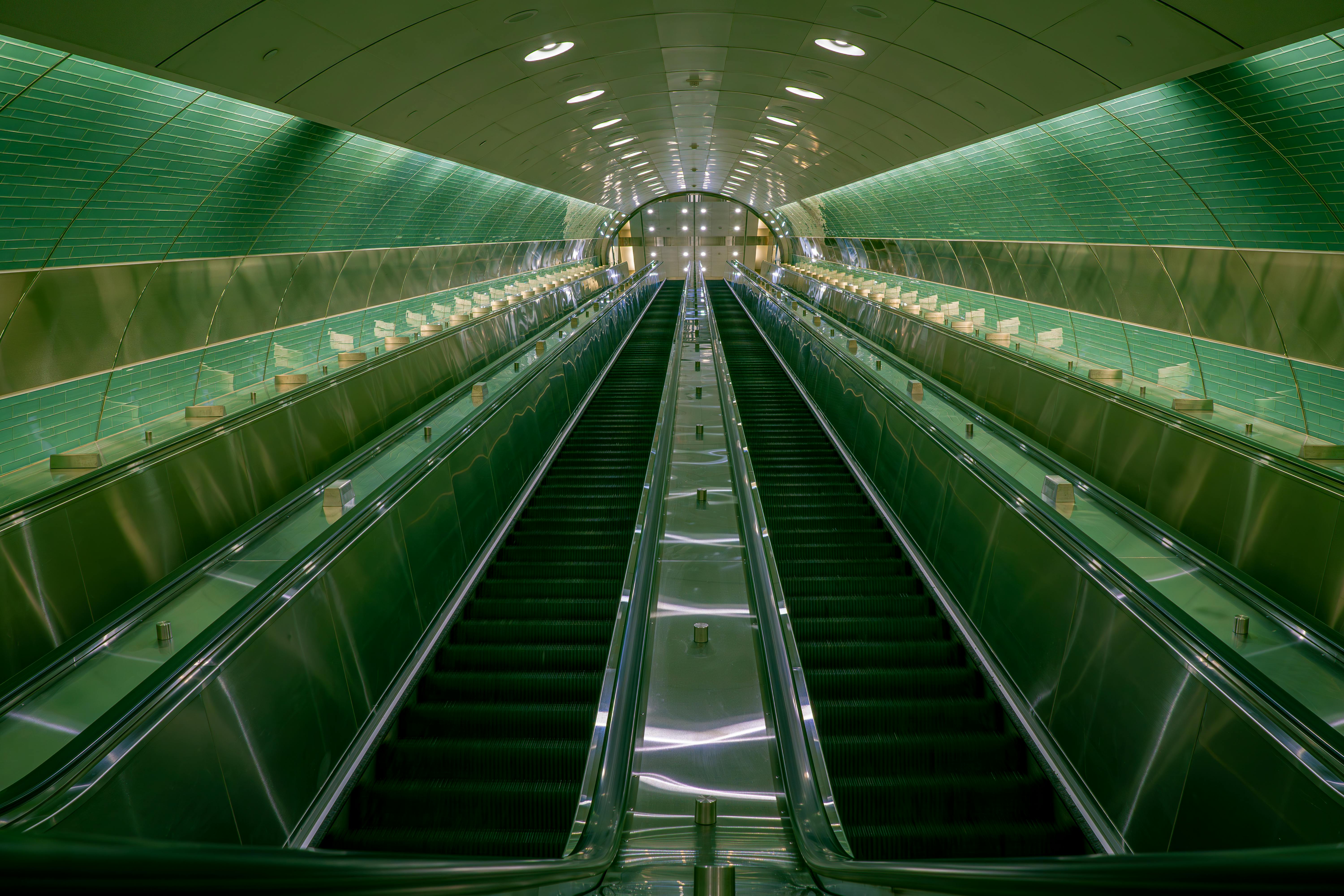 A sleek, modern escalator tunnel with shiny surfaces in New York.