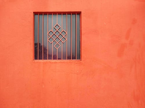 Bars on Window on Orange Wall