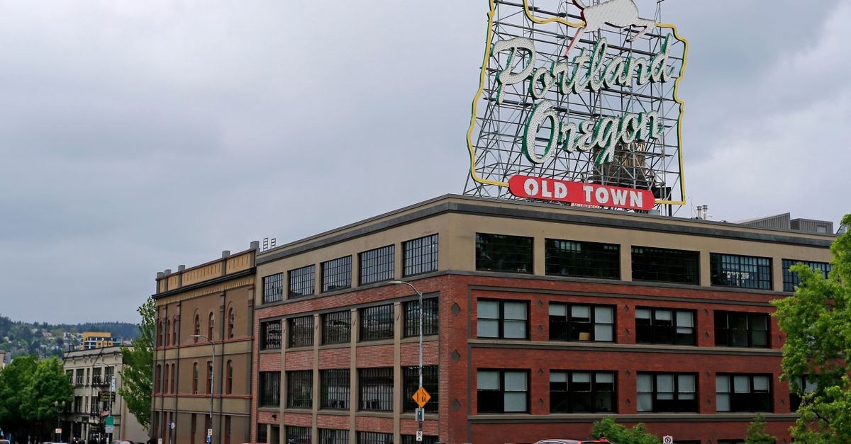 Famous Portland Oregon Old Town sign, capturing urban architecture and city vibe.