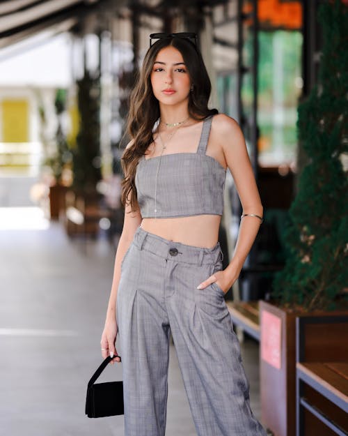 Young Woman in a Gray Crop Top and Pants 