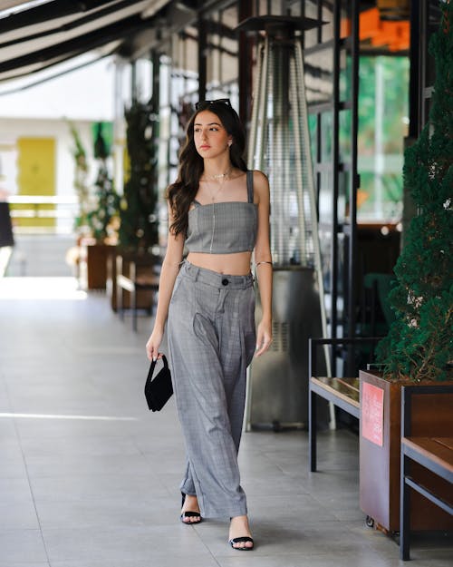 Beautiful Model in Gray Top Walking on Sidewalk