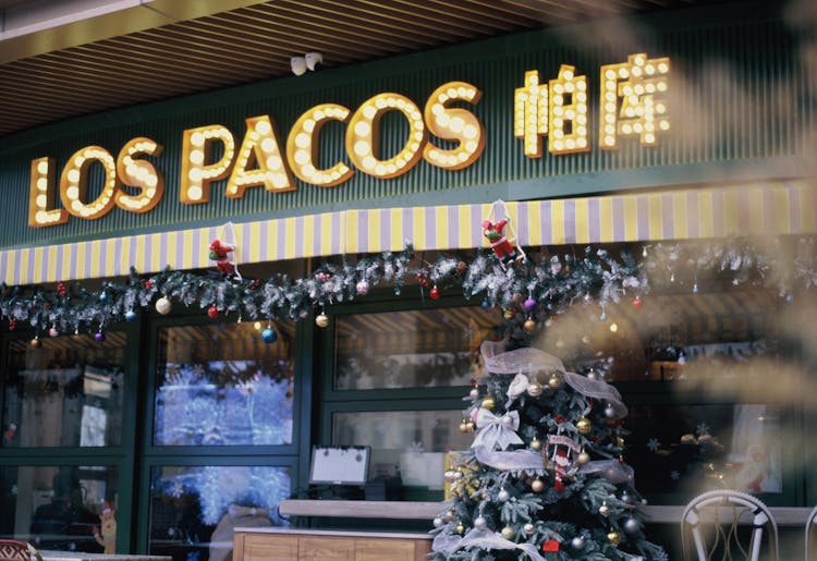 Christmas Decoration Under Store Name On Wall