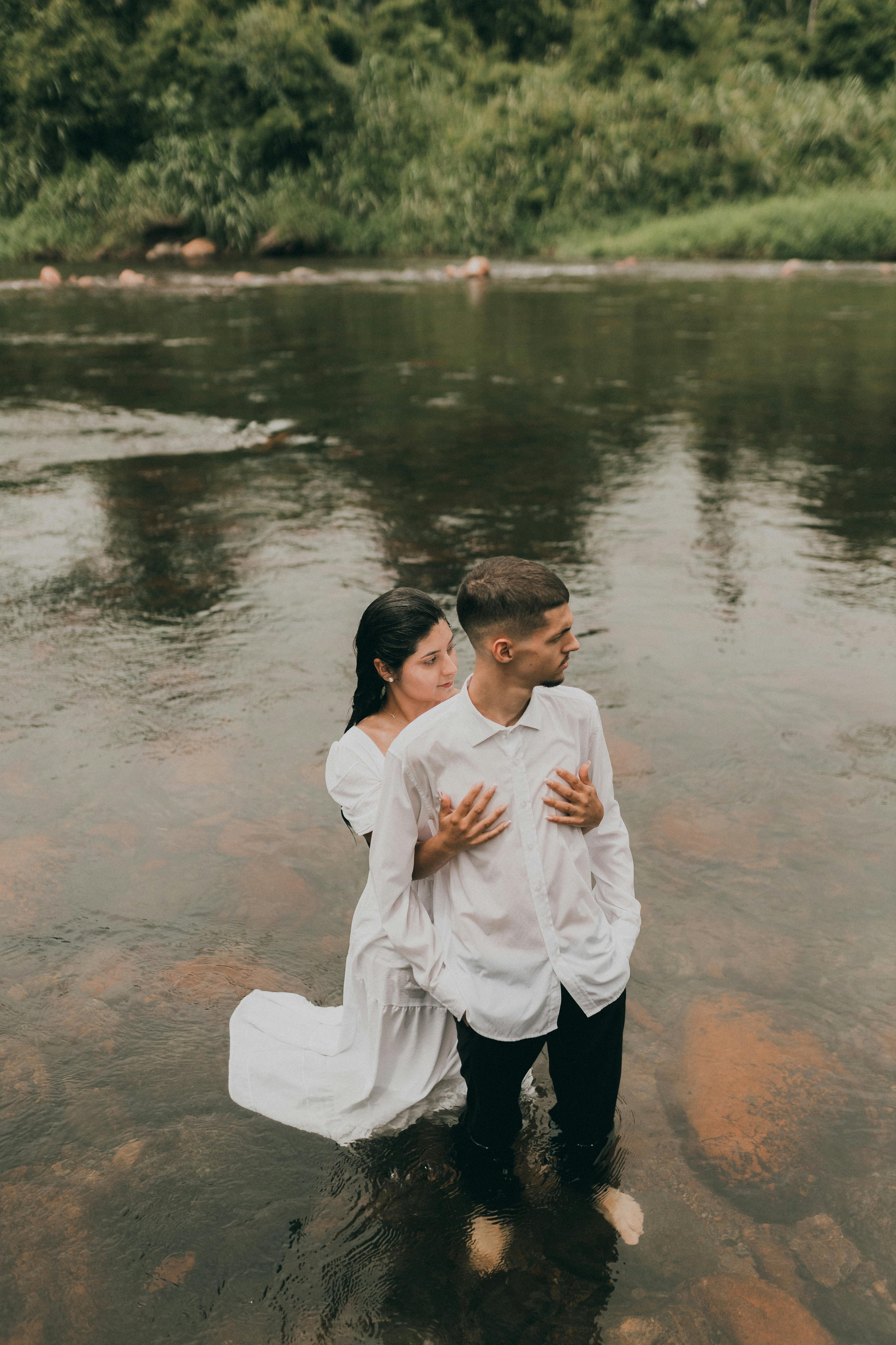 Young Woman and Man Posing Together in Water · Free Stock Photo