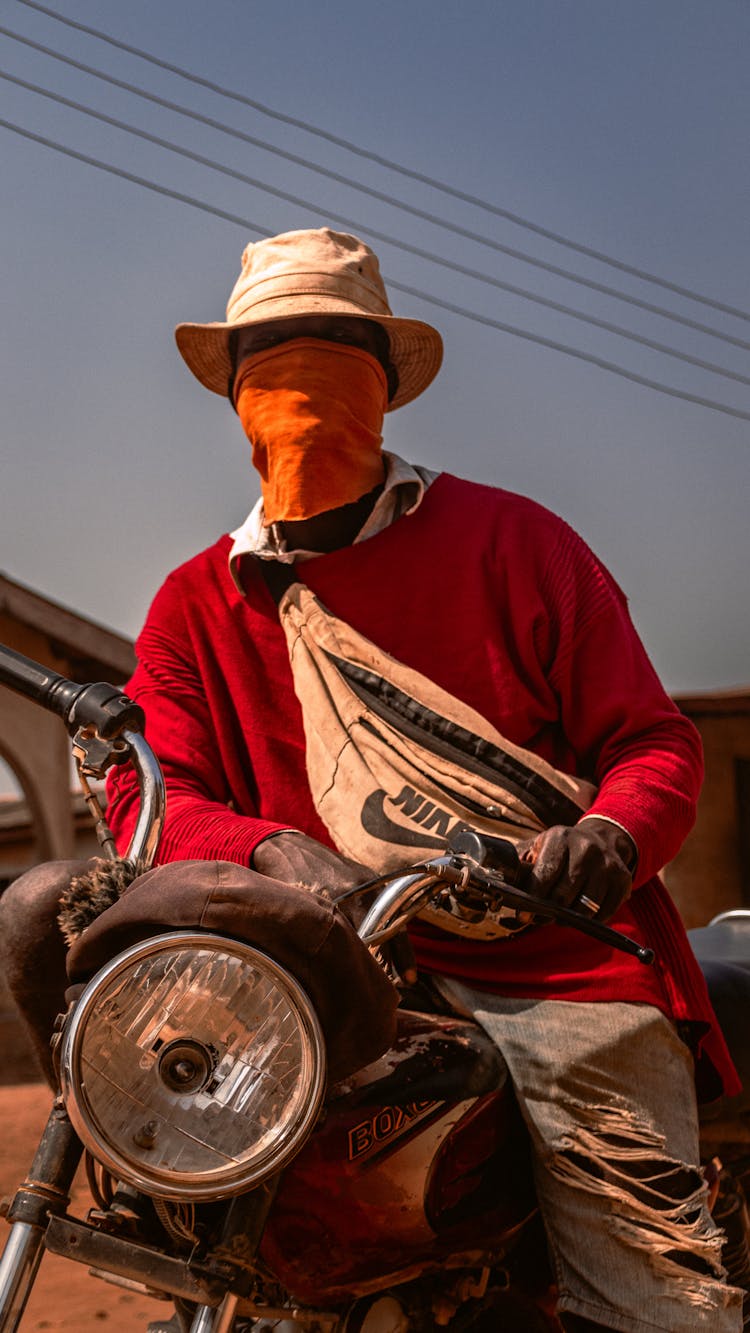 Man Wearing A Bandana Sitting On A Motorcycle