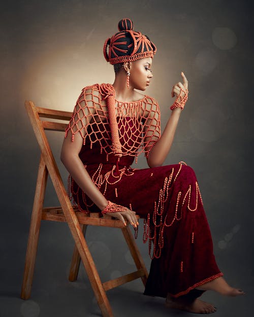 Woman in Traditional Clothing Sitting on Chair