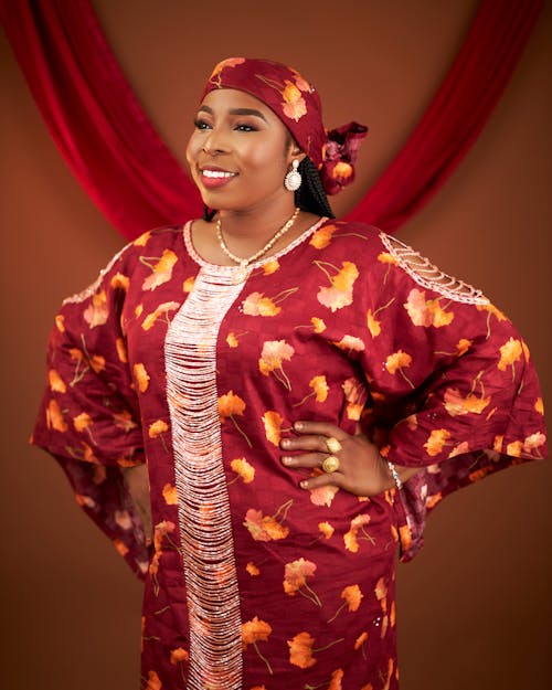 Female Model Wearing a Headscarf and a Red Floral Dress