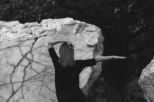 Back View of Woman Posing by Rock
