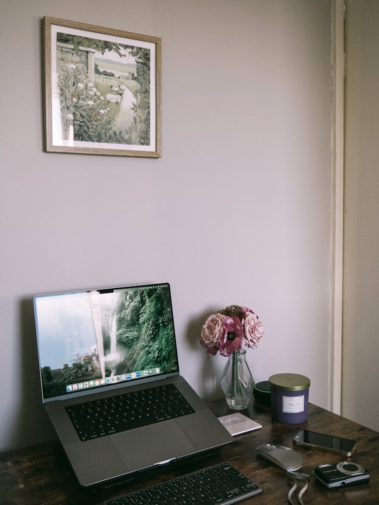 Laptop On A Stand With An External Keyboard And Mouse On The Desk