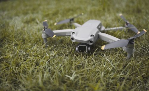 Free Close-up photo of a drone resting on a grass field in Zambia, showcasing outdoor technology. Stock Photo