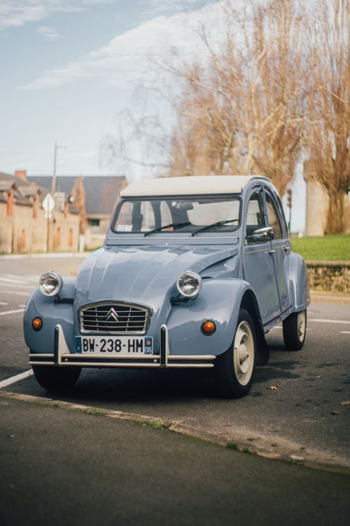 Free Classic Citroen 2CV car parked in an urban area with soft focus effect. Stock Photo