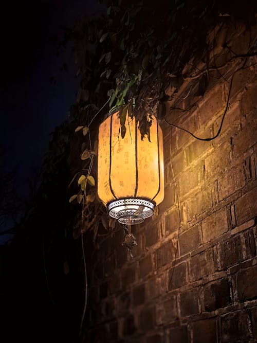 Traditional Lantern by Wall at Night