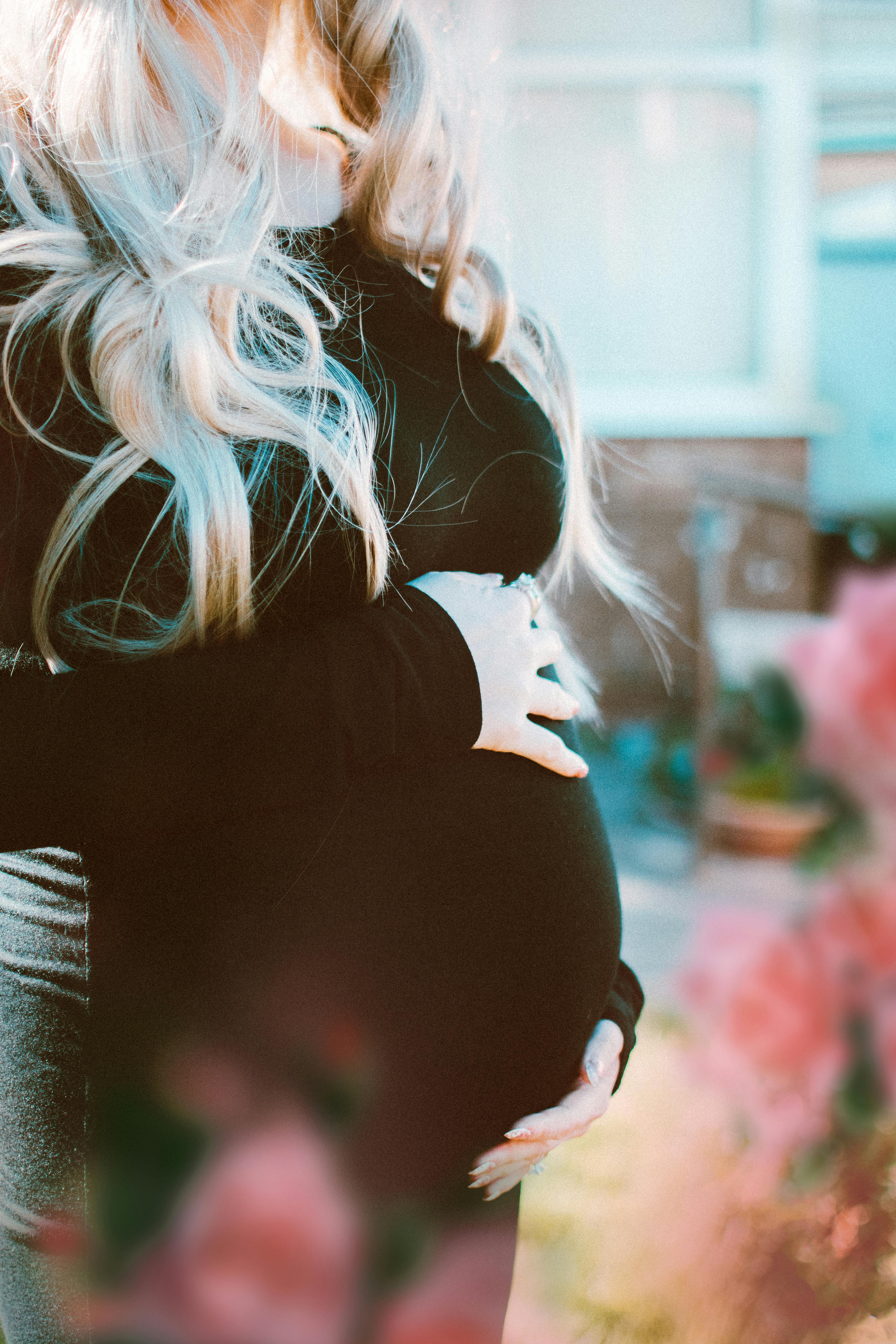 pregnant woman in black long sleeved dress