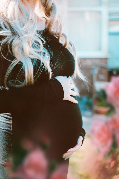 Pregnant Woman In Black Long-sleeved Dress