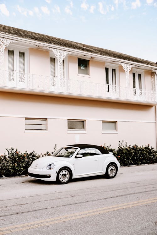 White Convertible Coupe Parked Beside House