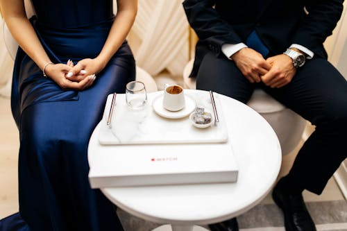 Elegant Couple Sitting by a Table 