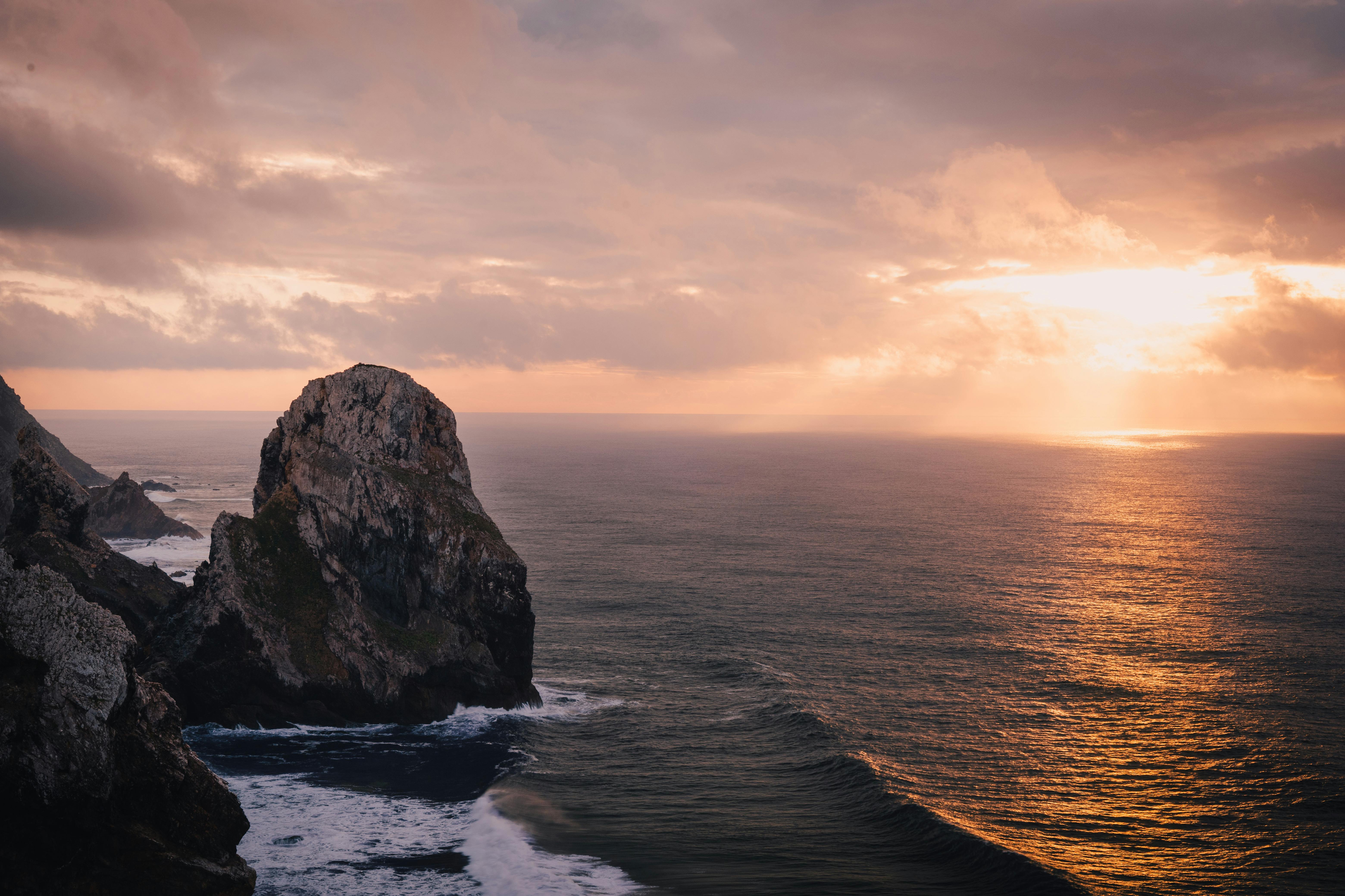 Breathtaking sunset view of rugged cliffs and ocean in Sintra, Portugal. Perfect coastal scene.