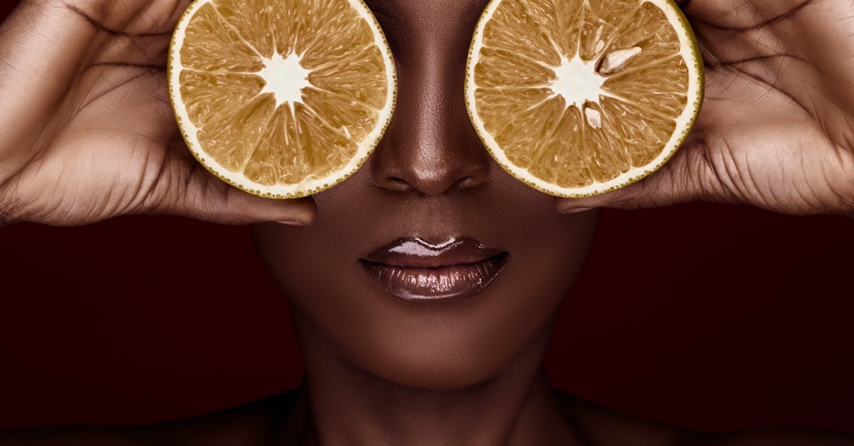 A close-up photo of freshly sliced lemons on a wooden cutting board.