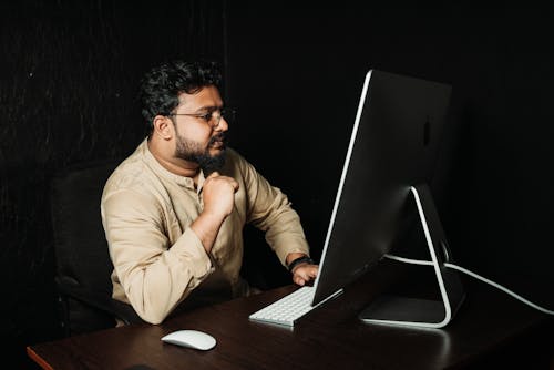 Man Working on Computer at Desk in Office