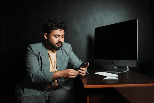 Man Working by Desk with Monitor Wireless Keyboard and Mouse