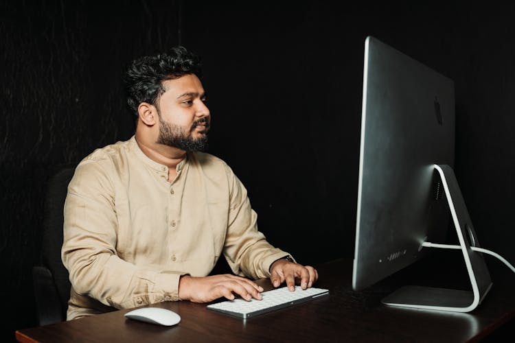 A Man Using A Computer 