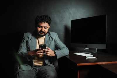 Man Using Computer Sitting on Chair · Free Stock Photo