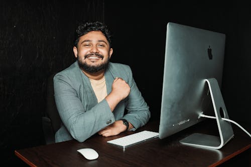 Smiling Man at Desk in Office