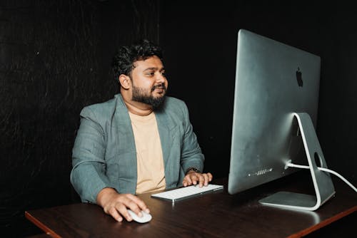 Man Working with Wireless Keyboard and Mouse in Office