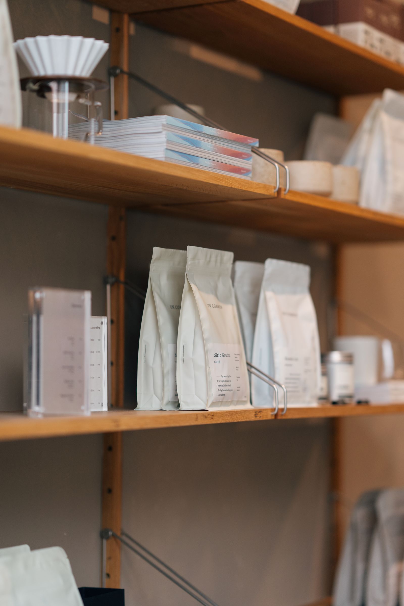 Custom printed pouches and cosmetic boxes lined up on a retail shelf